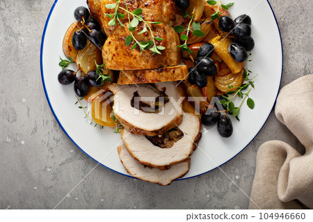 Roasted pork loin stuffed with apple and cranberry 104946660