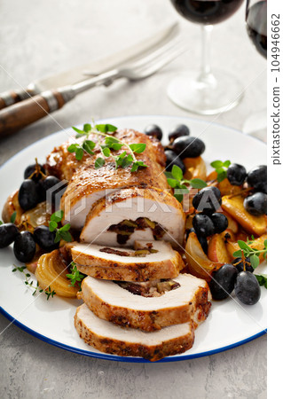 Roasted pork loin stuffed with apple and cranberry Roasted pork loin stuffed with apple and cranberry 104946662