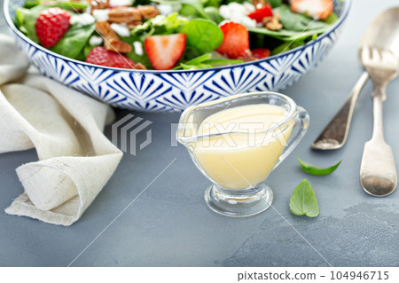 Italian dressing in a small sauce dish 104946715