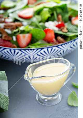 Italian dressing in a small sauce dish 104946716