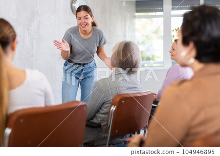 Young positive woman giving lecture in office 104946895