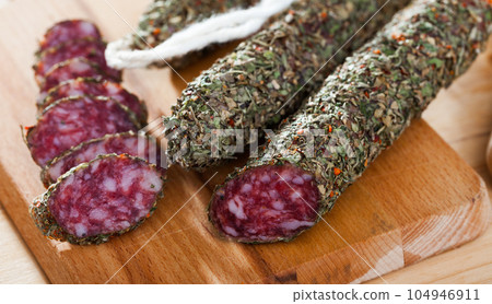 Fuet sausage coated with herbs Fuet sausage coated with herbs 104946911