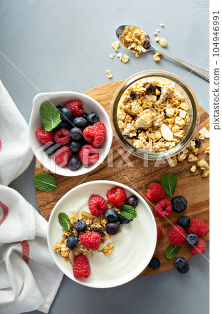 Plain yougurt with granola on side Plain yougurt with granola on side 104946991