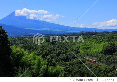 The Tokaido Main Line running along a mountain road with Mt. Fuji in the background The Tokaido Main Line running along a mountain road with Mt. Fuji in the background 104947273
