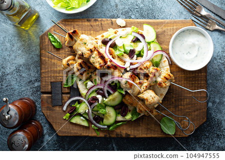 Chicken kebabs on a pita 104947555