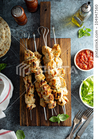 Chicken kebabs on a board Chicken kebabs on a board 104947560
