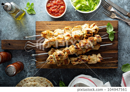 Chicken kebabs on a board Chicken kebabs on a board 104947561