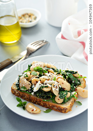 Beans with spinach on toast Beans with spinach on toast 104947569