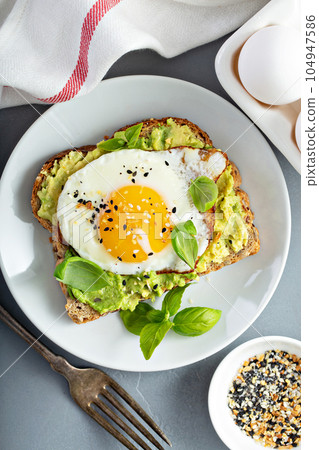 Avocado toast with fried egg Avocado toast with fried egg 104947586