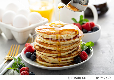 Fluffy buttermilk pancakes with syrup Fluffy buttermilk pancakes with syrup 104947592