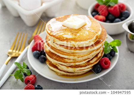 Fluffy buttermilk pancakes with syrup Fluffy buttermilk pancakes with syrup 104947595