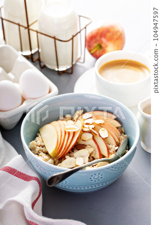 Healthy oatmeal with sliced apple and almonds Healthy oatmeal with sliced apple and almonds 104947597
