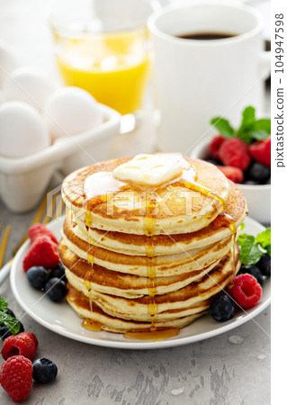 Fluffy buttermilk pancakes with syrup Fluffy buttermilk pancakes with syrup 104947598
