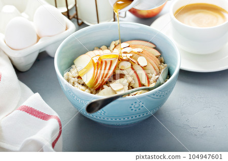 Healthy oatmeal with sliced apple and almonds 104947601