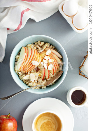 Healthy oatmeal with sliced apple and almonds 104947602
