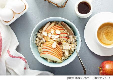 Healthy oatmeal with sliced apple and almonds Healthy oatmeal with sliced apple and almonds 104947603