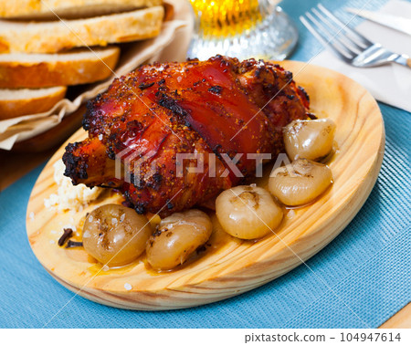 Roast pork knuckle with vegetables 104947614