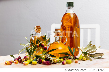 Bottles and carafes with olive oil 104947659
