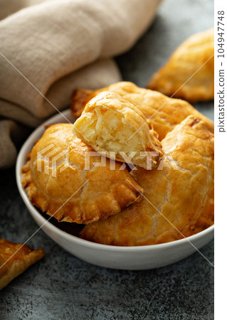 Hand pies with potato filling Hand pies with potato filling 104947748