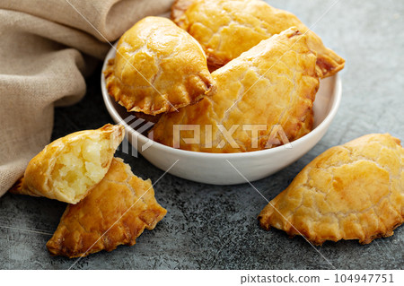 Hand pies with potato filling 104947751