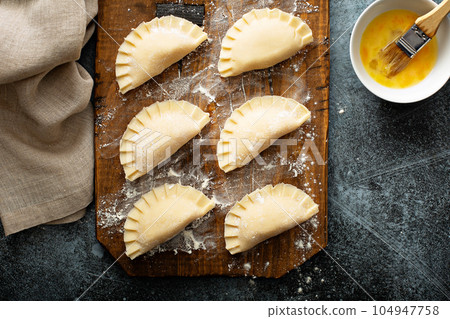 Hand pies with potato filling 104947758