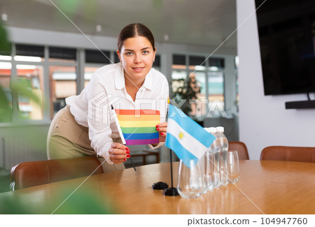 Young lady sets miniatures flags of Argentina and LGBT for international negotiations Young lady sets miniatures flags of Argentina and LGBT for international negotiations 104947760