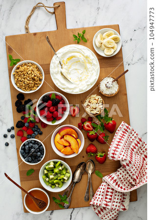 Yogurt bowl bar, big board with different toppings 104947773