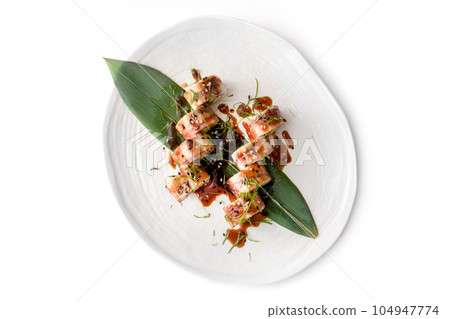 Sushi roll with eel on white plate on white concrete background 104947774