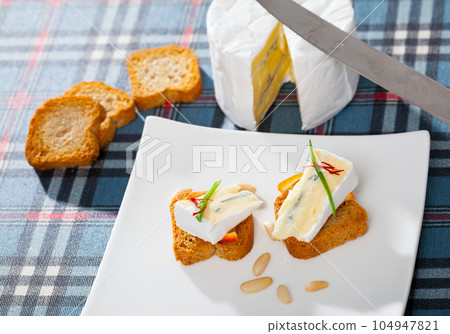 Delicious settee-bed with brie cheese Delicious settee-bed with brie cheese 104947821