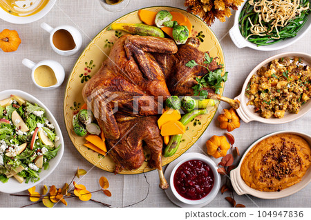 Traditional Thanksgiving table with turkey and sides 104947836