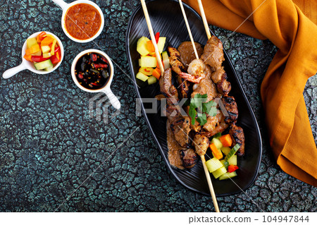 Asian meat and chicken skewers 104947844