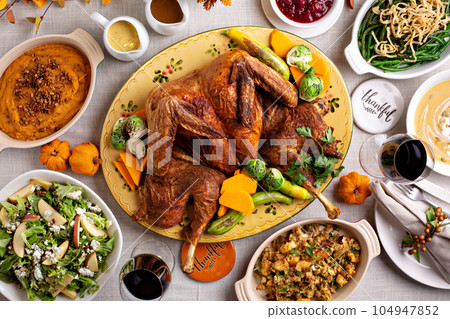 Thanksgiving dinner with whole turkey and sides 104947852