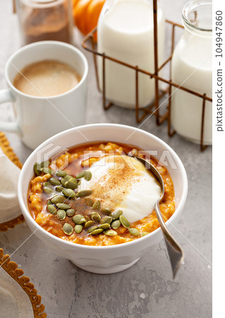 Pumpkin oatmeal with yogurt and pumpkin seeds Pumpkin oatmeal with yogurt and pumpkin seeds 104947860