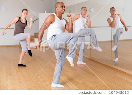 Latin american dancer practicing synchronous choreography with group 104948013
