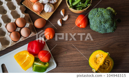 Flay lay food cooking vegetable broccoli egg pepper pea garlic background on wood texture copy space Flay lay food cooking vegetable broccoli egg pepper pea garlic background on wood texture copy space 104948315