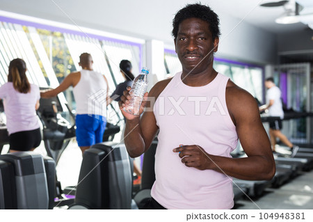 Man resting after workout with still water 104948381