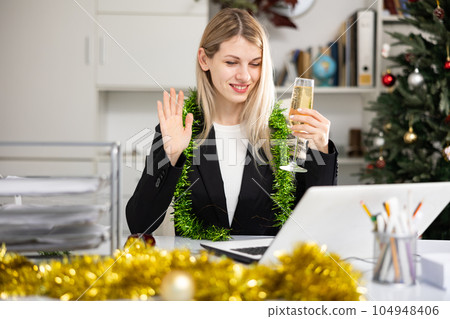Woman having video call in office during Christmas Woman having video call in office during Christmas 104948406