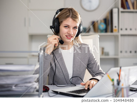 Portrait of woman call center worker in office 104948480