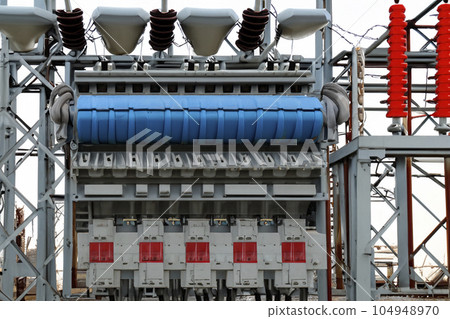 High voltage tower. High voltage. Electricity transmission power lines at sunset (high voltage pylon). High voltage circuit breaker in a power substation. Aerial view of high voltage power lines. 104948970