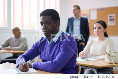 Positive man working at adult education class Positive man working at adult education class 104949030