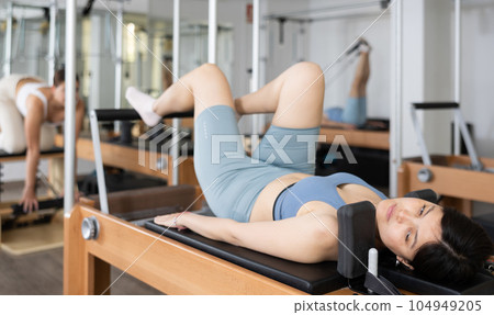 Young asian woman doing exercises on Pilates reformer 104949205