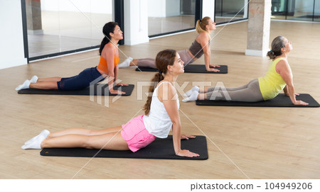Group of women exercising during pilates class 104949206