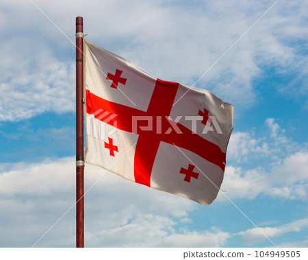 Flag of Georgia waving on cloudy sky 104949505