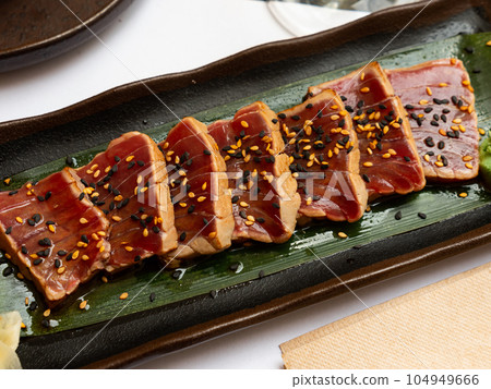 Popular Japanese dish Tataki from tuna with an appetizing ponzu sauce Popular Japanese dish Tataki from tuna with an appetizing ponzu sauce 104949666