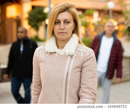 Portrait of a woman in a winter coat in winter city 104949753