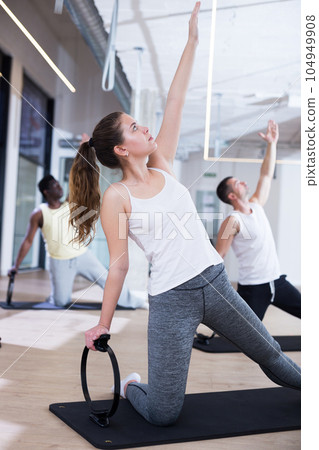 Young sporty woman exercising with pilates circle 104949908