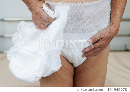 Asian elder senior woman patient wearing adult incontinence diaper pad in hospital. Asian elder senior woman patient wearing adult incontinence diaper pad in hospital. 104949978