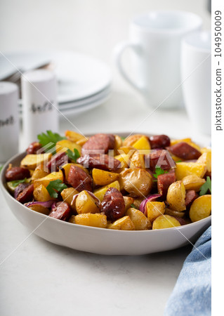 Traditional breakfast dish, potatoes with sausage 104950009
