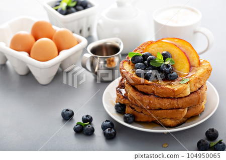 French toasts with fresh fruit for breakfast 104950065