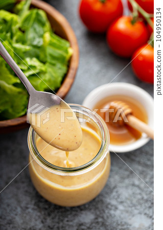 Homemade honey mustard sauce in a glass jar 104950134